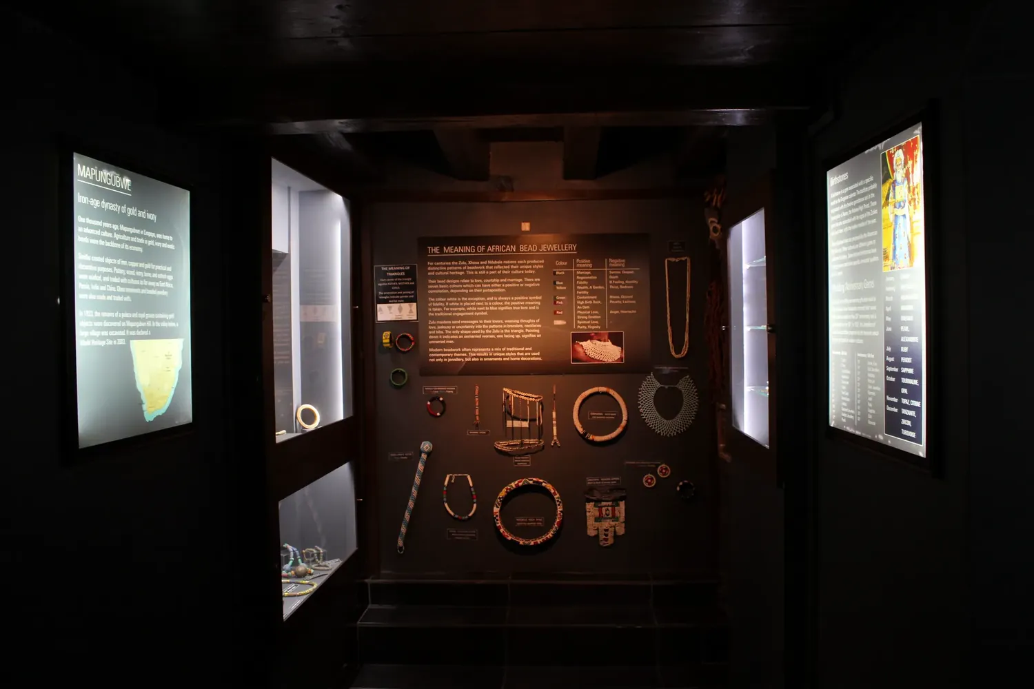 The alcove in Space C, with the Mapungubwe panel on the left, a wall of African bead jewellery in the centre and the birthstones panel on the right