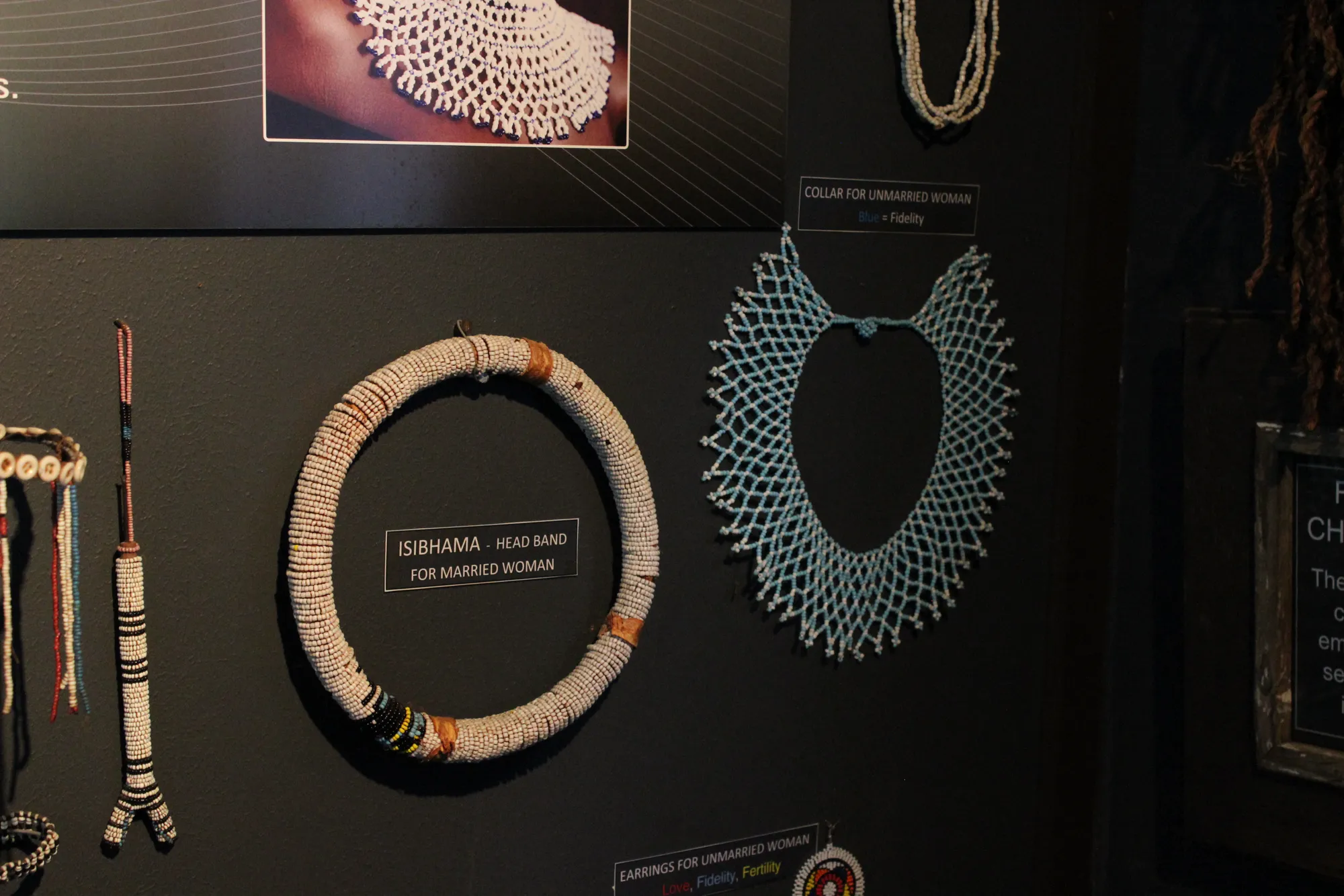 Traditional Zulu and Xhosa beadwork in the museum: the Isibhama head band for married women, collar for unmarried women, and earrings, all in symbolic colour
