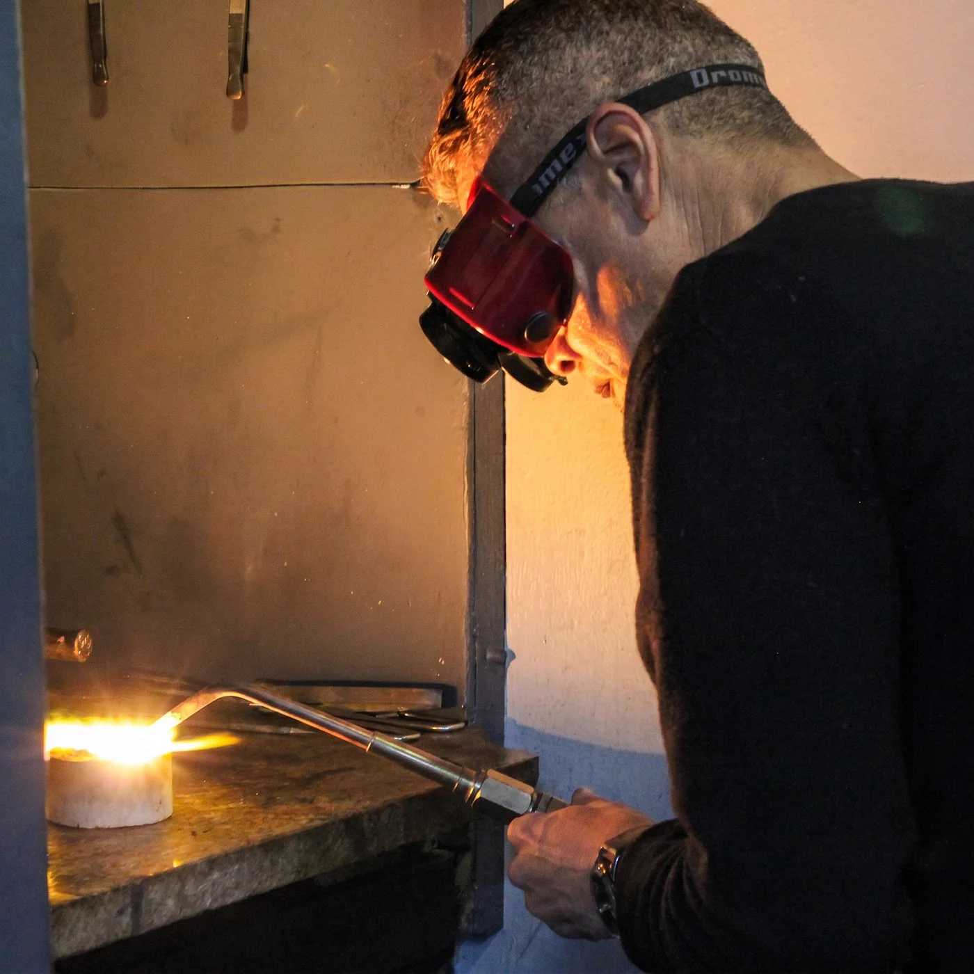 A goldsmith melting precious metal with a torch at the Prins and Prins atelier